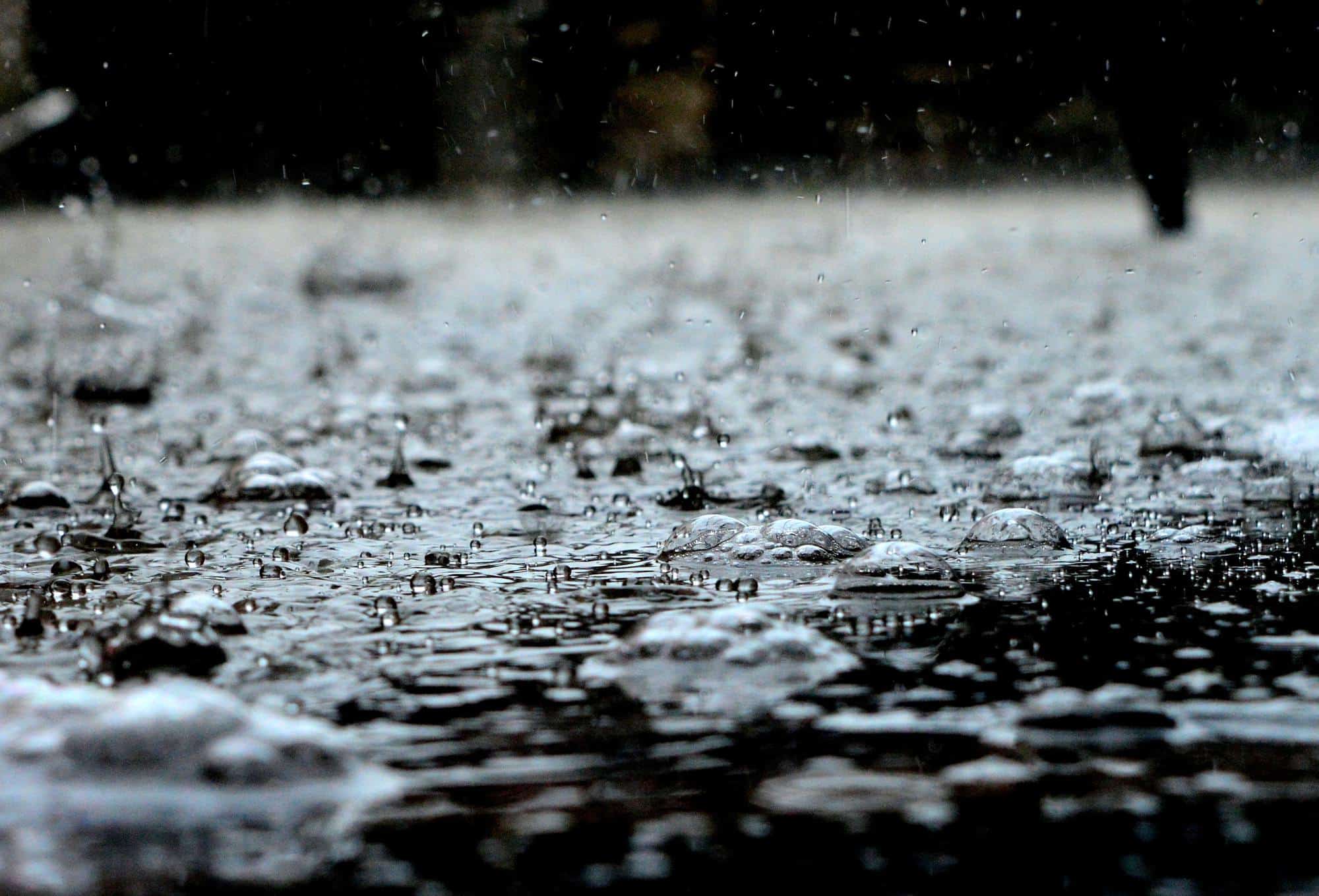 Close up of rain falling on a wet ground