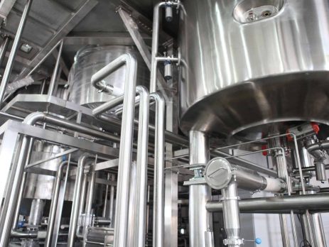 Metal pipes leading from chemical mixing tanks in a factory
