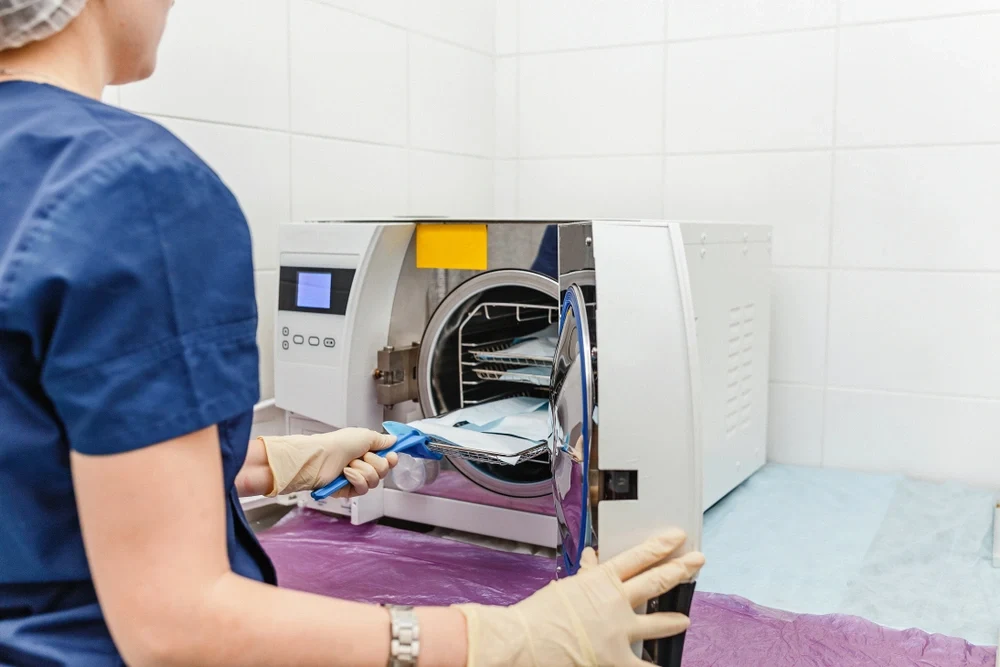 A nurse sterilising surgical instruments