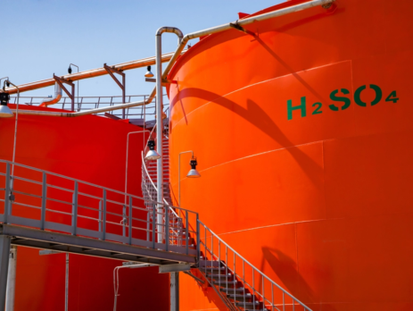 Large red chemical tanks outdoors