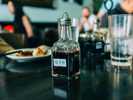A bottle of Chinese black vinegar on a table in a restaurant