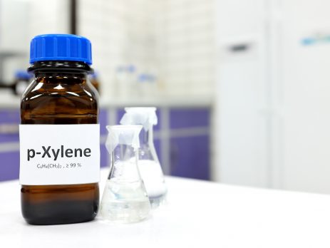 Selective focus of xylene liquid chemical compound in dark glass bottle inside a chemistry laboratory