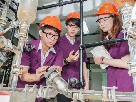 Engineer student turning pipeline pump for training in laboratory