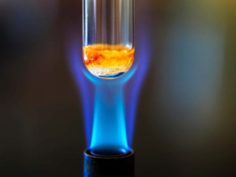 Close up of a bunsen burner flame with test tube above