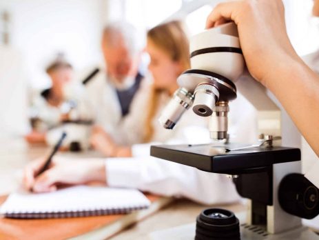 Closeup of student holding microscope