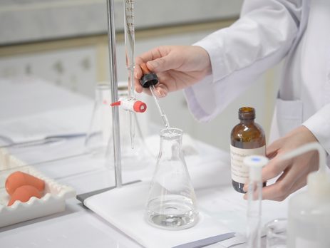 Scientist carrying out titration experiment in laboratory