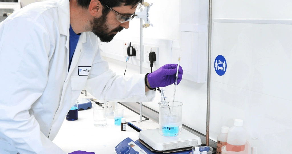lab apprentice conducting chemical test