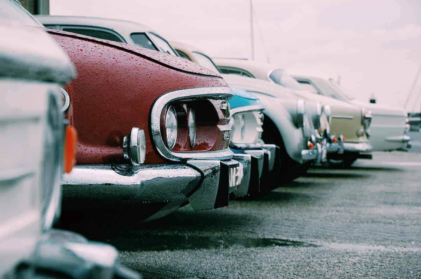 Old cars lined up in a car park