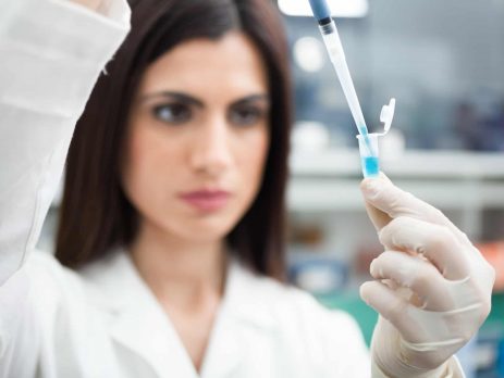 Scientist putting a sample in a test tube in a chemical laboratory