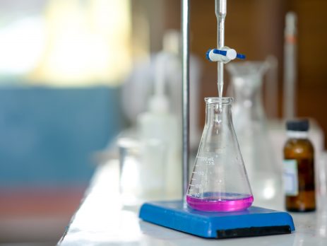 Erlenmeyer flask with purple solution in school chemistry lab