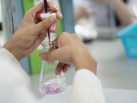 Close up of someone performing titration tecnique in analytical laboratory