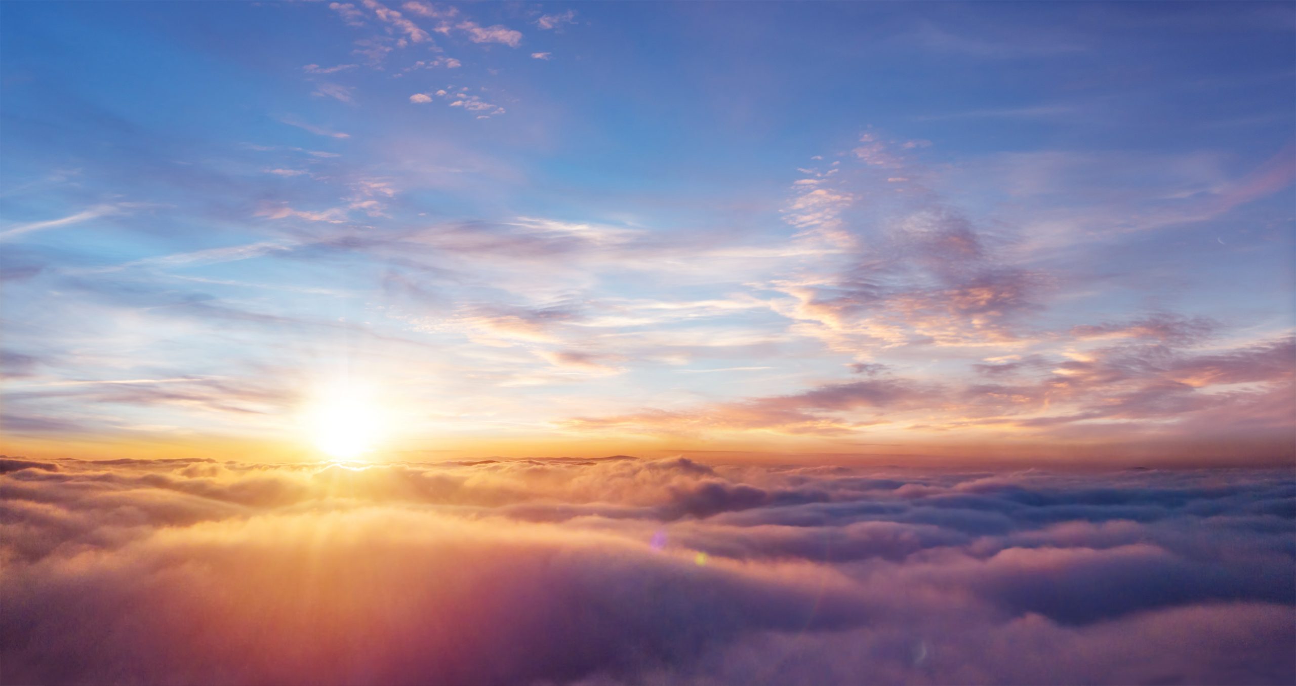 The sun setting above the clouds