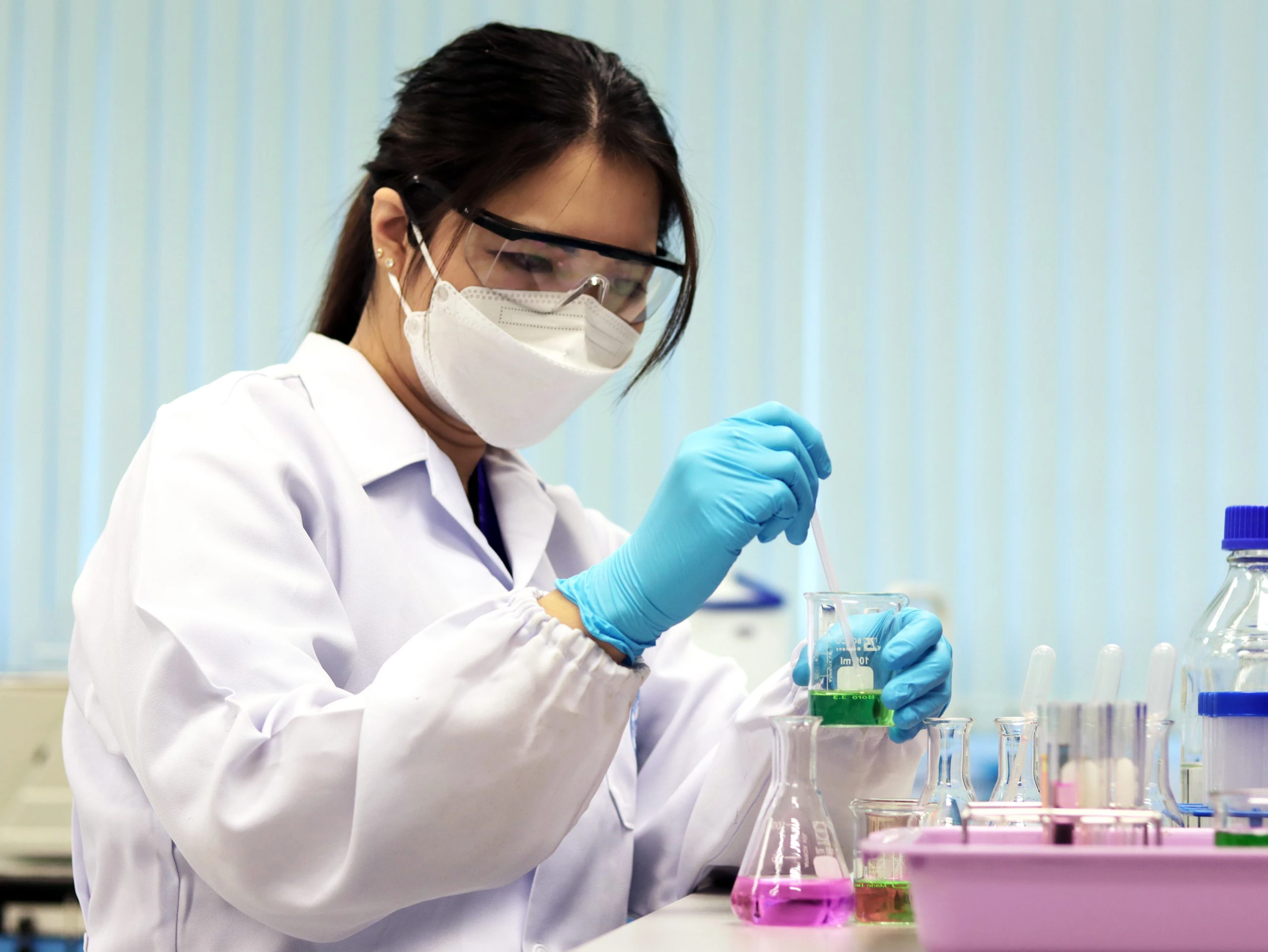 A scientist conducting an acid-base titration experiment.