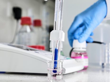 Scientist measuring the pH of a solution using a pH meter.