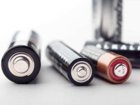 A close up of three alkaline batteries