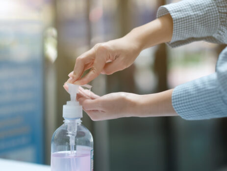A person using alcohol gel for cleaning their hand