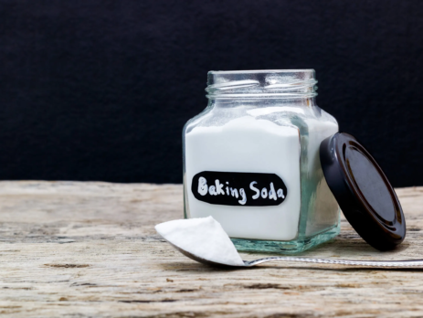 Glass jar of baking soda with spoon