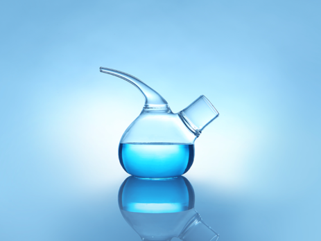 A retort flask containing blue liquid