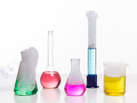 Different types of flasks used in chemical laboratory experiments filled with different coloured liquids