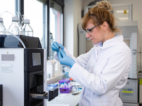 A scientist using a chromatography machine