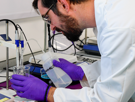A chemist testing the pH of oxidising acids