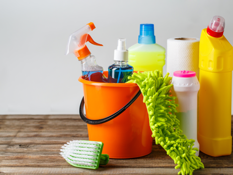 Orange bucket full of household cleaning products