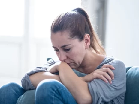 Woman-on sofa looking depressed