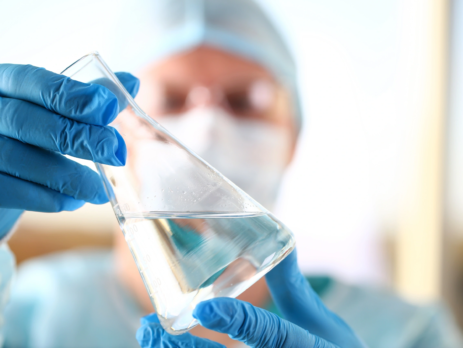 Scientist holding flask of purified water