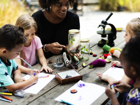 Teacher perform easy science experiments outdoors