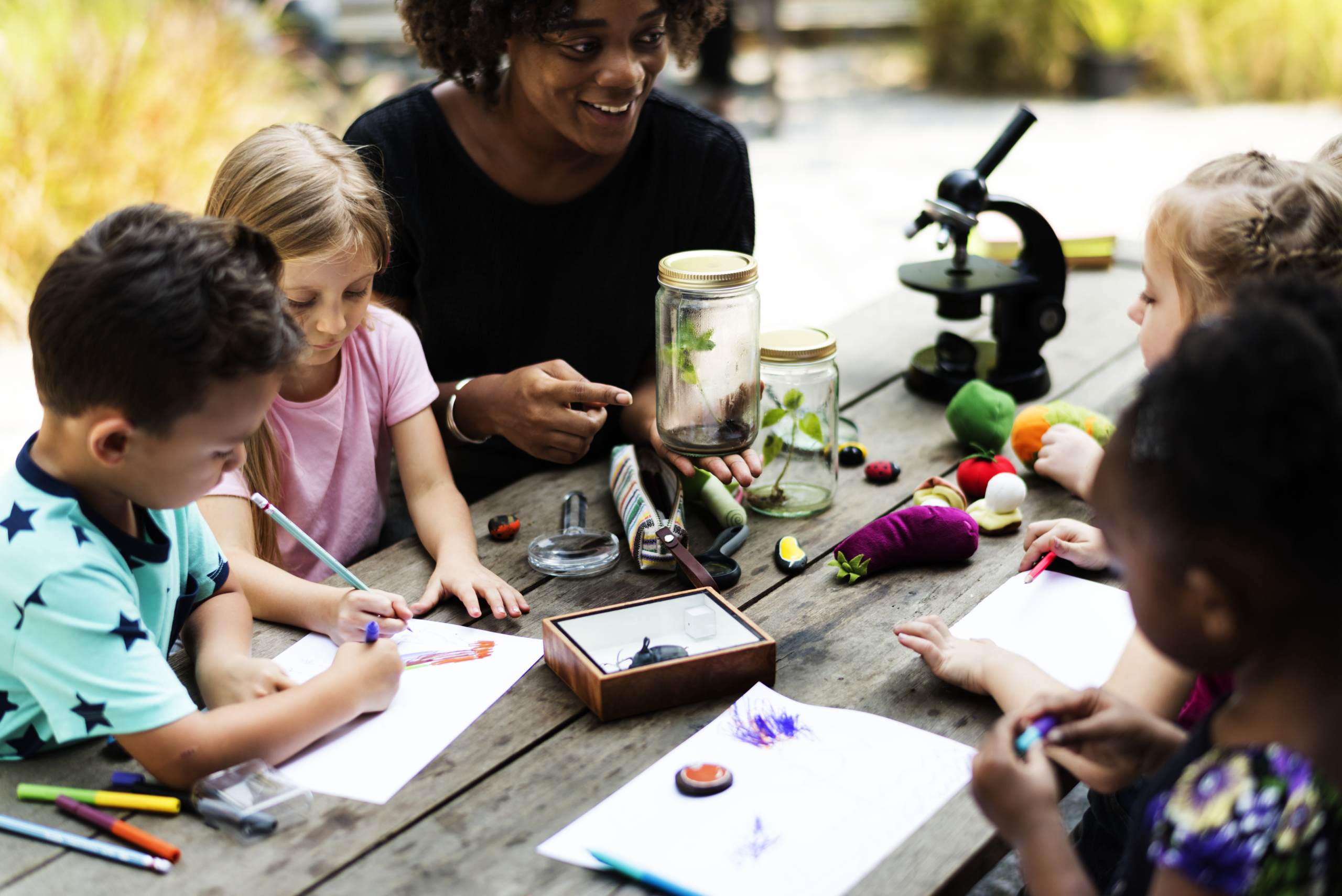 Teacher perform easy science experiments outdoors