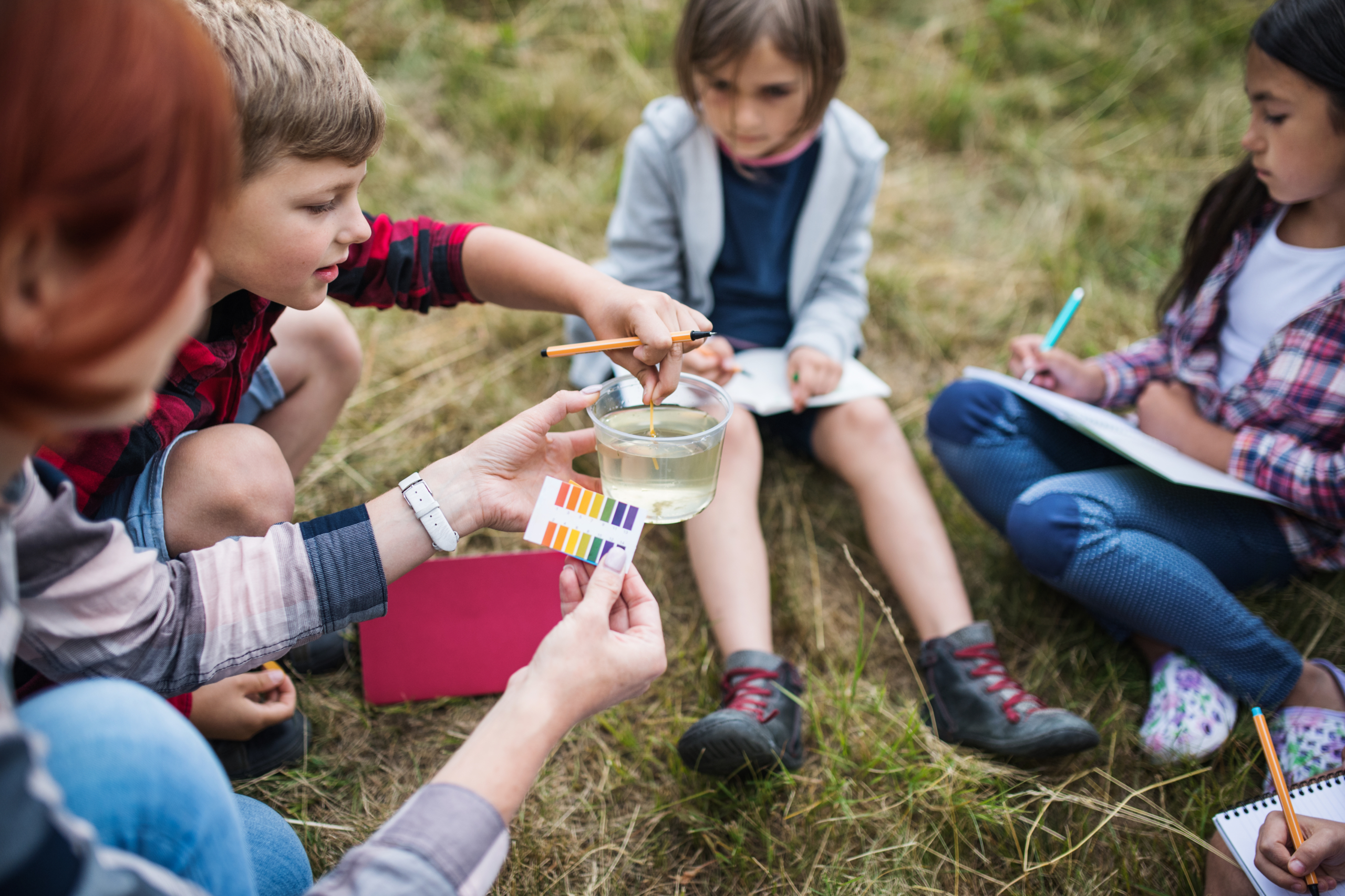 Children conducting easy science experiments outside