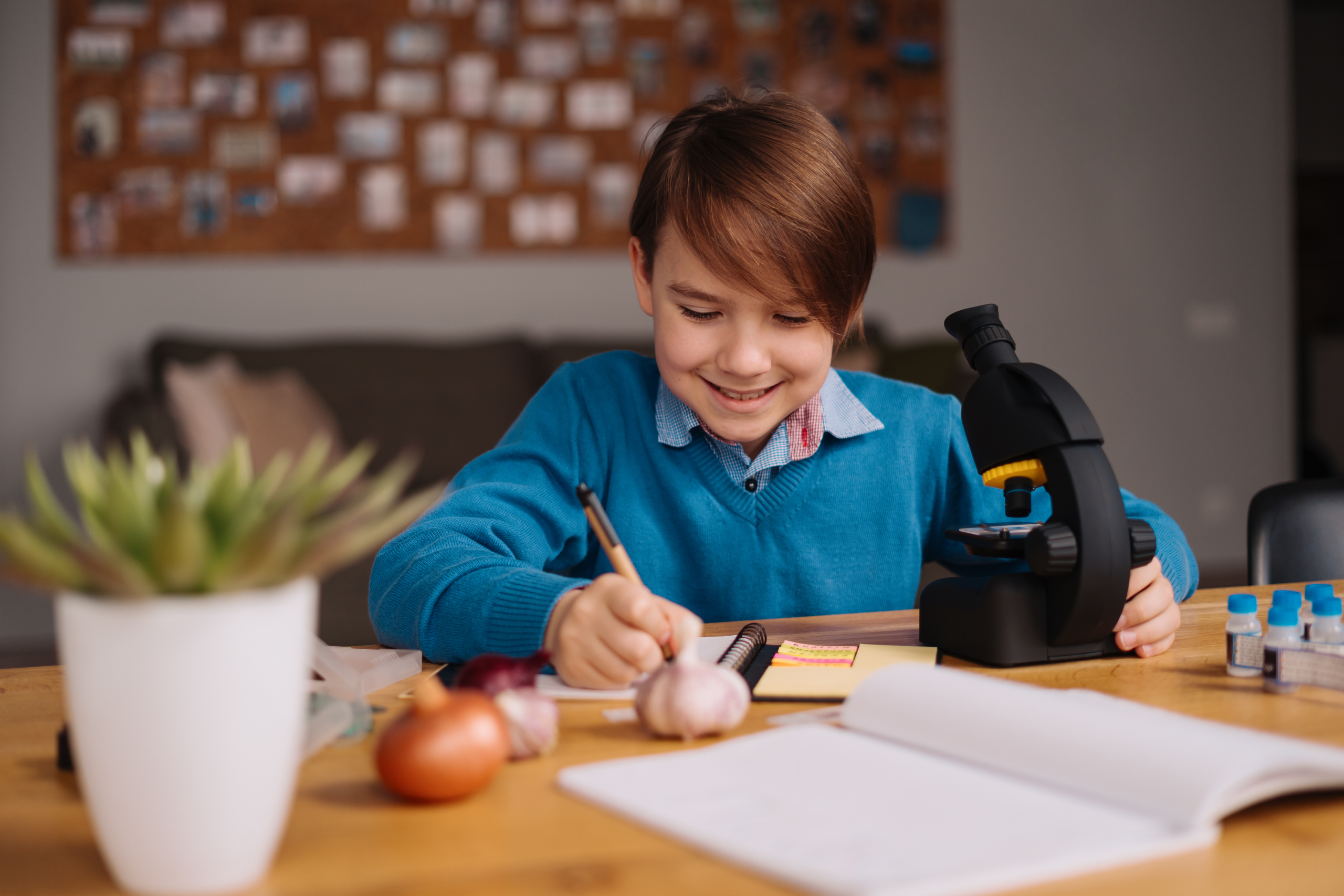 Child writing in a guide to developing STEM skills at home