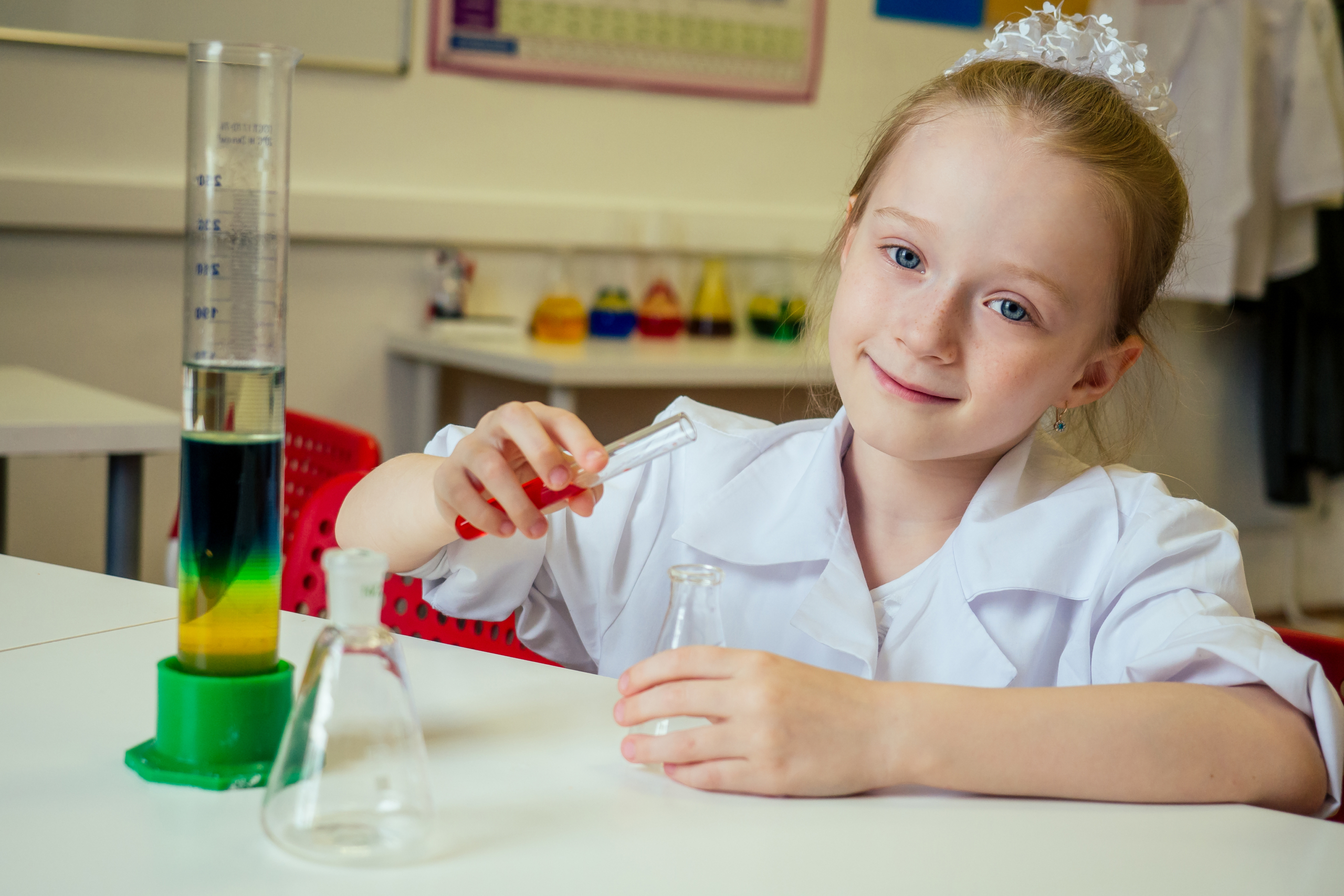Young girl with test tubes engaging in science experiments for schools