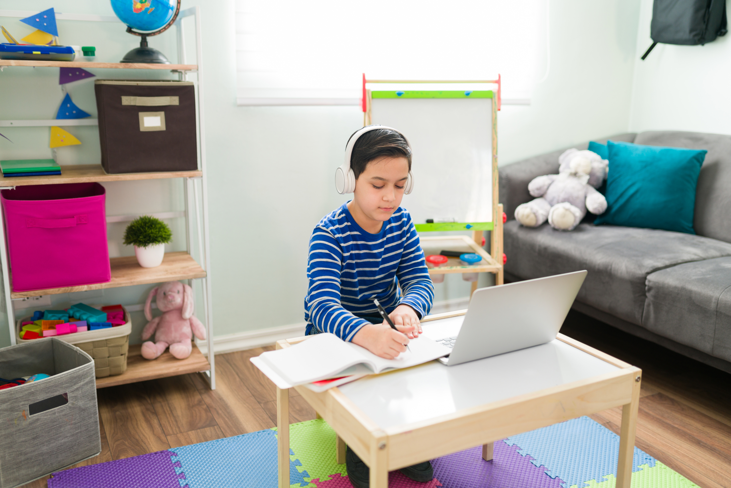 Young boy in his room during STEM activities for kids on his computer