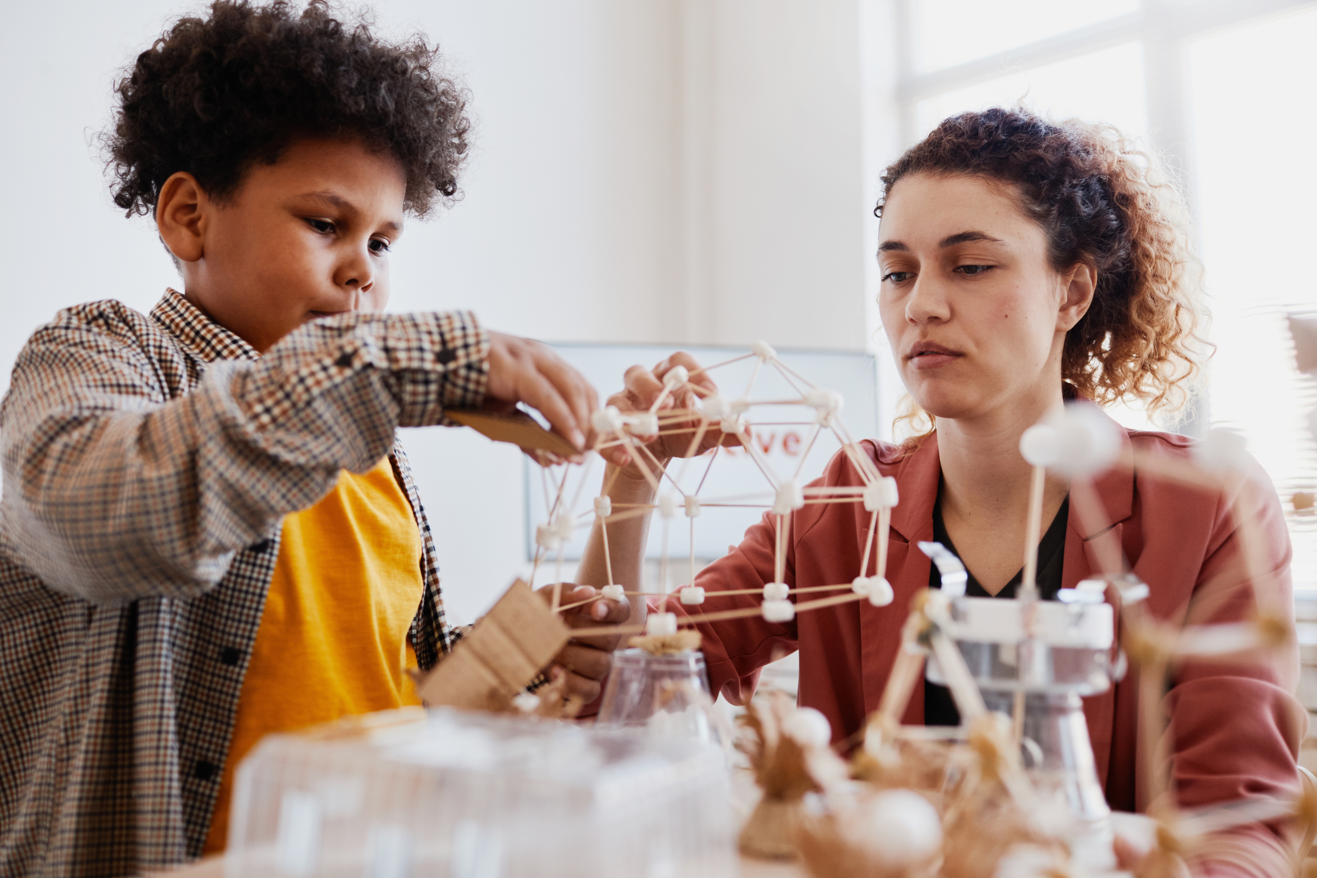 Mother and son playig with geometric models